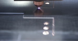 Laser cutting line of metal sheet to create smaller parts