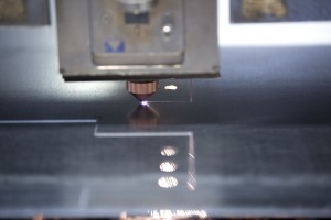 Laser cutting line of metal sheet to create smaller parts