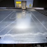 active laser cutter being used to cut metal components